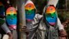 Kenyan gays, lesbians and others supporting their cause, wear masks to preserve their anonymity as they stage a protest against Uganda's increasingly tough stance against homosexuality, outside the Uganda High Commission in Nairobi, Kenya, Feb. 10, 2014. 