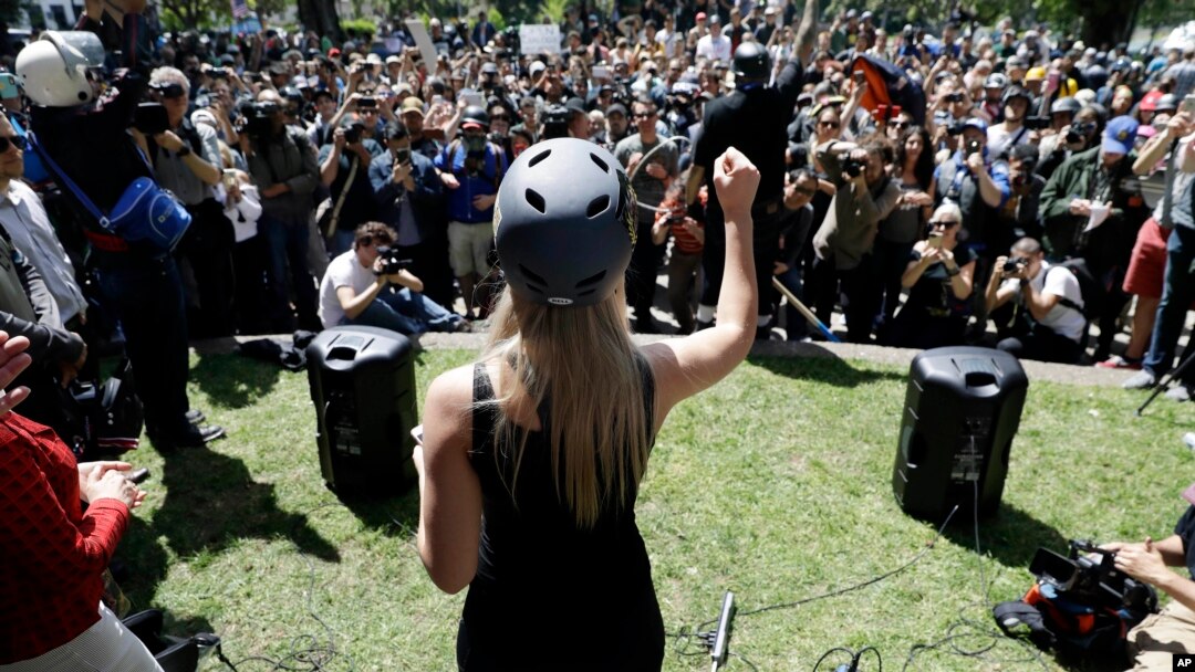 In this April 27, 2017 photo, Lauren Southern wears a protective helmet as she speaks during a rally for free speech near the University of California, Berkeley campus in Berkeley, California. (AP Photo/Marcio Jose Sanchez)