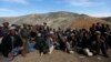 Displaced Afghan villagers gather near the site of a landslide that occurred May 2 at the Argo district in Badakhshan province, May 5, 2014.
