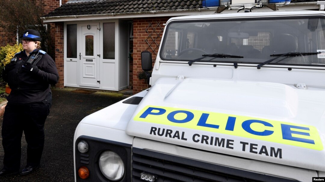 FILE - A police officer stands guard outside of the home of former Russian military intelligence officer Sergei Skripal, in Salisbury, Britain, March 6, 2018. 