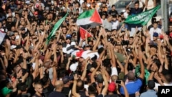 Mourners carry the body of Mohammed Obeid, a 20 year-old Palestinian killed in a clash with Israeli police on June 27, during his funeral in east Jerusalem, July 1, 2019.