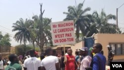 Youths protest against French President Emmanuel Macron's declarations over how Cameroon is handling the conflict in its English-speaking regions, outside the French embassy in Yaounde, Feb. 24, 2020. (Moki Edwin Kindzeka/VOA)