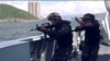 This screengrab taken from undated handout three-minute promotional video received on Aug. 1, 2019, from China's People's Liberation Army (PLA) Hong Kong Garrison shows armed PLA soldiers on a boat during a drill in Hong Kong waters. 