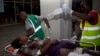 An injured woman is stretchered from an ambulance into Kenyatta National Hospital, Nairobi, Sunday May 4, 2014. Two improvised explosive devices went off on buses along one of busiest highways in the Kenyan capital, Nairobi killing one person and wounding