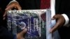 Officials hold copies of the final report of a judicial investigation into corruption in government and state-owned companies during former President Jacob Zuma's tenure from 2009 to 2018, during the official hand-over at Union Building in Pretoria, South Africa, June 22, 2022.
