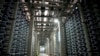 A worker is surrounded by pipes inside a desalination plant in the city of Hadera, Israel, May 16, 2010.