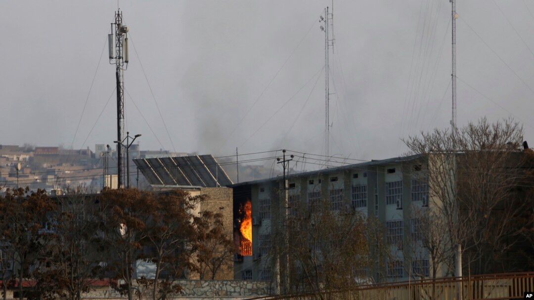 Flames rise from a government building after an explosion and attack by gunmen, in Kabul, Afghanistan, Monday, Dec. 24, 2018. 