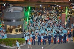 In this Thursday, June 20, 2019, photo, EVA Air flight attendants protest at the entrance to the EVA Air headquarters in Taoyuan, Taiwan.