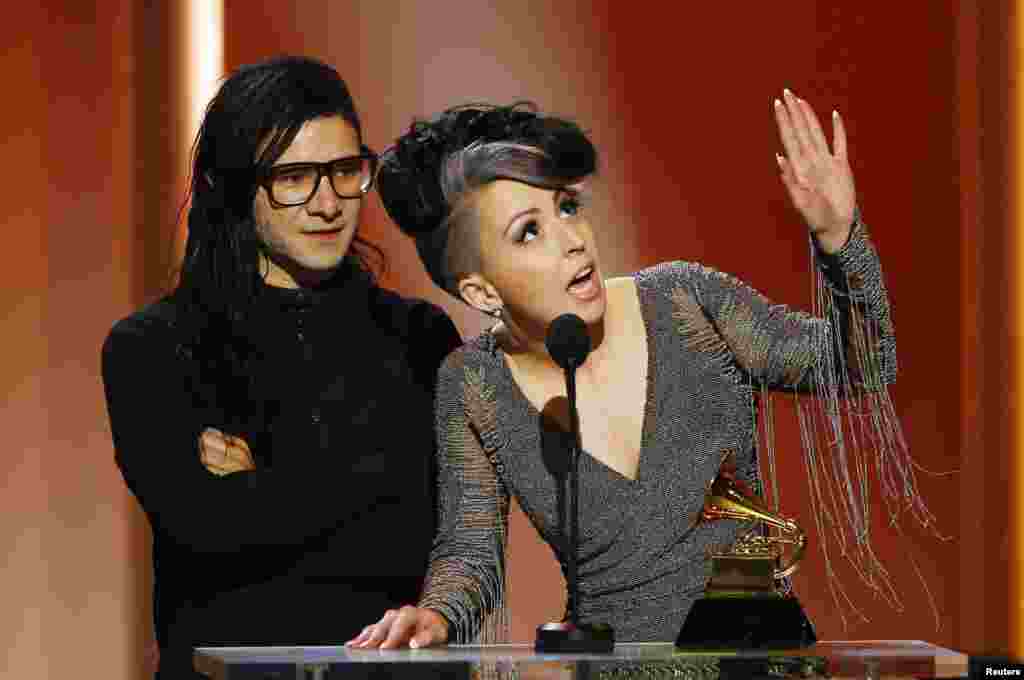 Skrillex and Sirah (R) accept their award for best dance recording for their work "Bangarang" in 55th annual Grammy Awards in Los Angeles, California, Feb. 10, 2013.