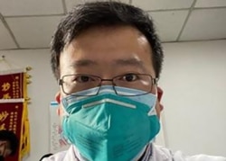 FILE - Coronavirus whistleblower Dr. Li Wenliang, whose death was confirmed on February 7, 2020, is shown in his protective mask, at the Wuhan Central Hospital, China.
