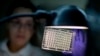 FILE - А мicrobiologist reads a panel to check on a bacterium's resistance to an antibiotic in а lab at the U.S. Centers for Disease Control and Prevention in Atlanta, Georgia, Nov. 25, 2013.