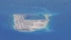 Chinese dredging vessels are purportedly seen in the waters around Fiery Cross Reef in the disputed Spratly Islands in the South China Sea in this still image taken by a P-8A Poseidon surveillance aircraft, May 21, 2015. 