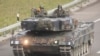 FILE - Soldiers of the Swiss Army are seen in a Leopard 2 tank, taking part in a military exercise near Othmarsingen, Switzerland Nov. 28, 2022. 