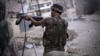 A Free Syrian Army fighter fires his weapon at Syrian Army positions in Aleppo, Syria. Piece by piece, Syria's rebels are slowly starting to expand their arsenal and get their hands on more advanced weapons, September 11, 2012