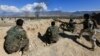 FILE - Afghan security forces take a position during a gunbattle with Taliban forces in Laghman province, Afghanistan, March 1, 2017.