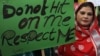 FILE - Pakistani woman holds a sign as she observes the International Day for the Elimination of Violence against Women, in Lahore, Pakistan, Nov. 25, 2015. 