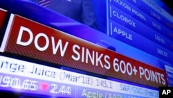 A television screen displays the Dow Jones industrial average story, on the floor of the New York Stock Exchange, Feb. 2, 2018. 