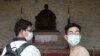 People wear face masks to protect against the spread of the new coronavirus at Chiang Kai-shek Memorial Hall in Taipei, Taiwan, Thursday, Feb. 27, 2020.
