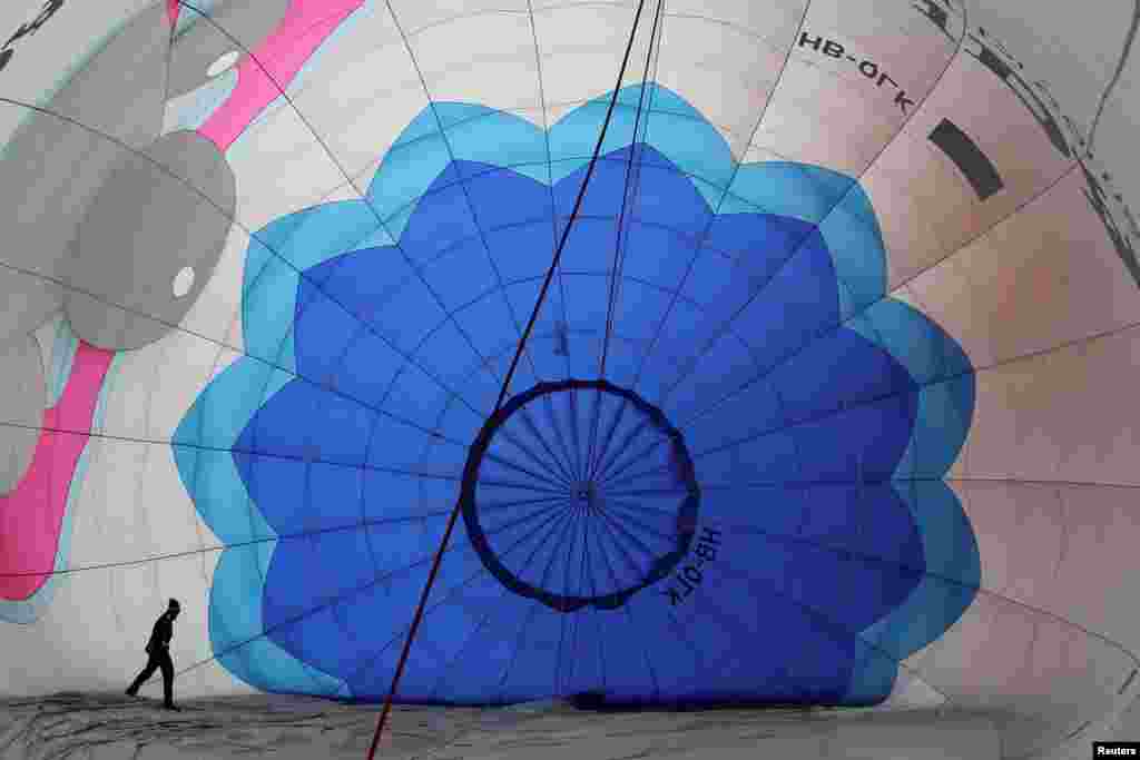 A Participant prepares a balloon for inflation during the International Hot Air Balloon Week in Chateau-d'Oex, Switzerland, Jan. 27, 2018.