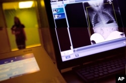 File -- Good jobs for high school graduates in the booming health care industry include health technologists, workers who perform tests and procedures ordered by doctors and other health care personnel.