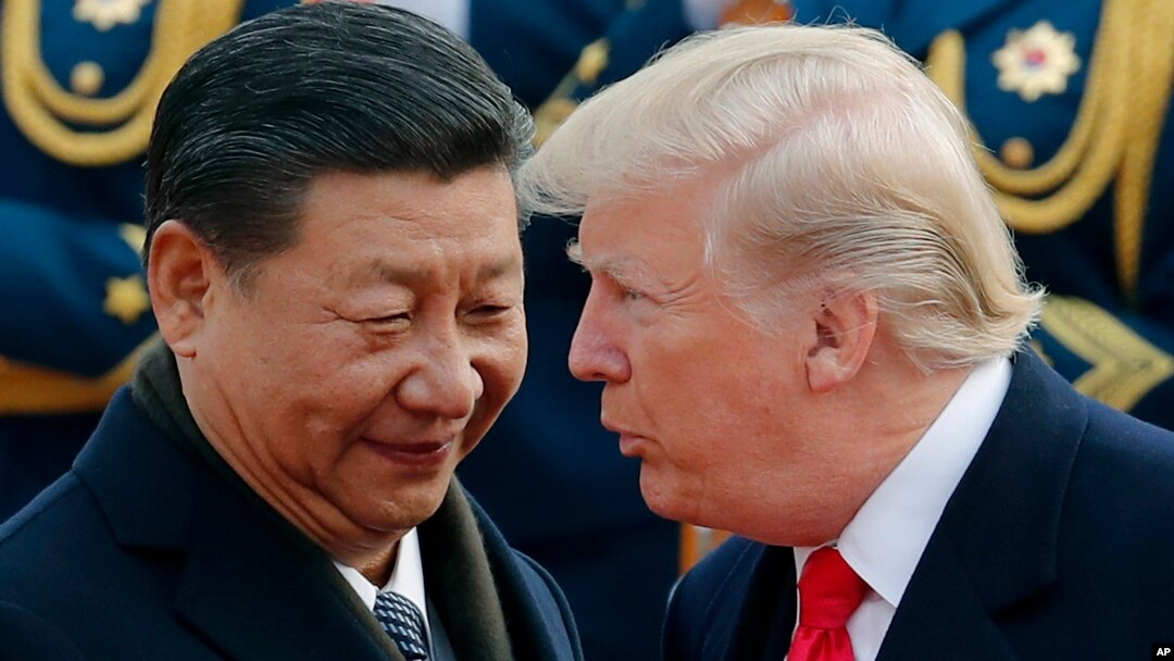 FILE - U.S. President Donald Trump, right, chats with Chinese President Xi Jinping in Beijing, China. 