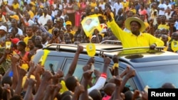 FILE - Uganda's president and presidential candidate Yoweri Museveni of the ruling party National Resistance Movement waves to his supporters as he arrives at a campaign rally in Entebbe, Uganda, Feb. 10, 2016.