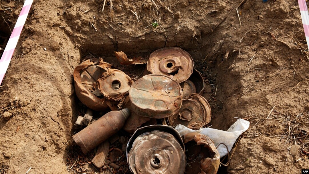 FILE - Landmines and debris from historic fighting are seen during the bomb disposal in Jebel Lemuni, 15km south of Juba, South Sudan, on January 30, 2019.