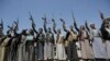 Shi'ite Houthi tribesmen hold their weapons as they chant slogans during a tribal gathering showing support for the Houthi movement, in Sanaa, Yemen, Sept. 21, 2019.