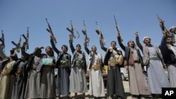 Shi'ite Houthi tribesmen hold their weapons as they chant slogans during a tribal gathering showing support for the Houthi movement, in Sanaa, Yemen, Sept. 21, 2019.