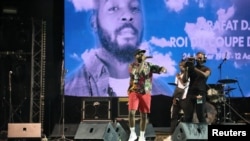 FILE - Nigerian singer Davido performs during the tribute ceremony for Ange Didier Houon, known as DJ Arafat, at the Felix Houphouet-Boigny stadium in Abidjan, Ivory Coast, Aug. 30, 2019. 