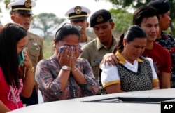 Relatives of soldiers who were killed in the five-month siege of Marawi city in southern Philippines by the Islamic State group-aligned fighters, lay white roses at the Marawi Memorial pylon to commemorate its 2nd anniversary, May 23, 2019.