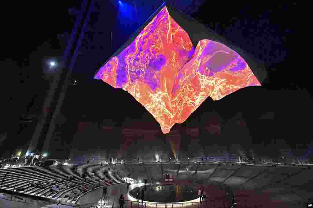Visitors watch the upside down hanging sculpture of the Matterhorn mountain at the exhibition &quot;The Call of the Mountains&quot; in the Gasometer in Oberhausen, Germany.