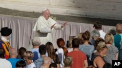 Pope Francis asks the faithful to keep safety distance as he arrives during his weekly general audience in San Damaso courtyard at the Vatican, Wednesday, Sept. 9, 2020. (AP Photo/Andrew Medichini)
