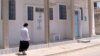Jewish woman walks in the neighborhood of Hara Kbira Tunisia's southeastern island of Djerba. (L. Bryant/VOA)