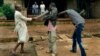 FILE - Muslim men organized in militias with machetes rough up a Christian man while checking him for weapons in the Miskine neighbourhood of Bangui, Central African Republic, Dec. 13, 2013.