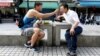 Lin Chinxuan, left, 29, feeds Austin Haung, 32, a dessert in Taipei, Taiwan, Nov. 11, 2018. Lin Chinxuan and Austin Haung are a couple and together they run Hiwow studio photographing LGBTQ couples, who they say mostly come from overseas.