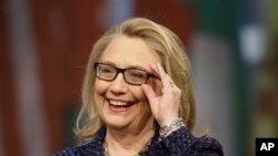Secretary of State Hillary Rodham Clinton adjusts her glasses during a Global Townterview at the Newseum in Washington, January 29, 2013.