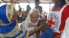 FILE - A 13-year-old Central African Republic refugee cries in the arms of relatives in Lolo, east Cameroon, April 21, 2017.