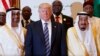 President Donald Trump poses for photos with King Salman, right, and others at the Arab Islamic American Summit, at the King Abdulaziz Conference Center, May 21, 2017, in Riyadh, Saudi Arabia.