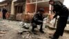 Policemen collect evidence from the site of a bomb attack at the district court in Islamabad, Pakistan, Mar. 3, 2014. 