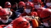 Medics and rescue personnel carry an injured person from the debris of a collapsed building in Izmir, Turkey, Oct. 31, 2020. 