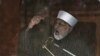 Sufi cleric and leader of the Minhaj-ul-Quran religious organisation Muhammad Tahirul Qadri addresses his supporters from behind the window of an armored vehicle on the second day of protests in Islamabad, January 15, 2013.