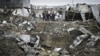 Afghan security members of Contrack company stand at the scene of a car bomb explosion in Kabul, Afghanistan, December 17, 2012. 