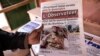 A man buys a newspaper with the picture of Paul-Henri Sandaogo Damiba, the leader of the mutiny and of the Patriotic Movement for the Protection and the Restauration (MPSR), in Ouagadougou on Jan. 25, 2022. 