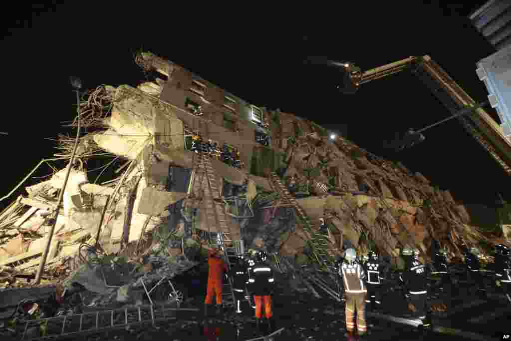 Rescue workers search a toppled building