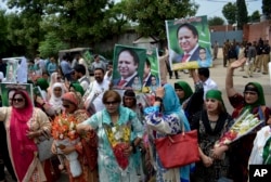 FILE - Supporters of Pakistan's jailed ex-Prime Minister Nawaz Sharif gather outside the Adiala jail where he is being held, in Rawalpindi, Pakistan, July 19, 2018.