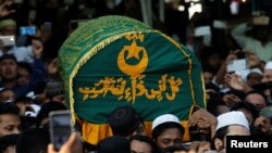FILE - Supporters carry the coffin of Ko Ni, a prominent member of Myanmar's Muslim minority and legal adviser for Myanmar's ruling National League for Democracy, in Yangon, Myanmar, Jan. 30, 2017.