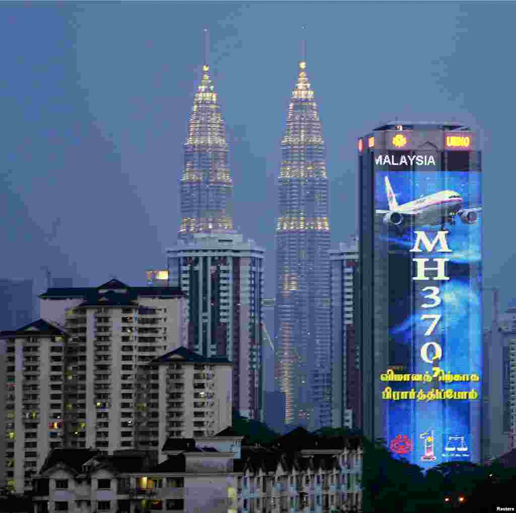 An image in support of Malaysia Airlines Flight MH370 is seen on the United Malays National Organisation building in Kuala Lumpur, March 19, 2014.