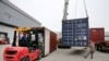 FILE - Men work on unloading the rubber imported from Belt and Road Initiative (BRI) countries at a bonded logistics center in Nantong, Jiangsu province, China, May 17, 2019.
