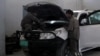 Men work on an armored vehicle at a garage in Afghanistan.